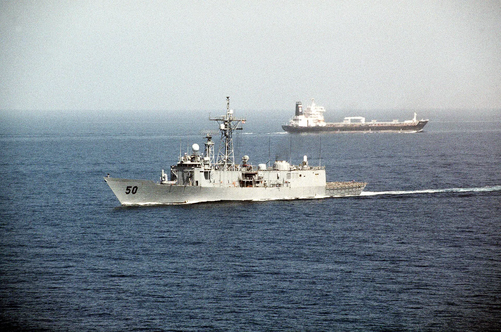 A US Navy frigate escorting a tanker in the Persian Gulf