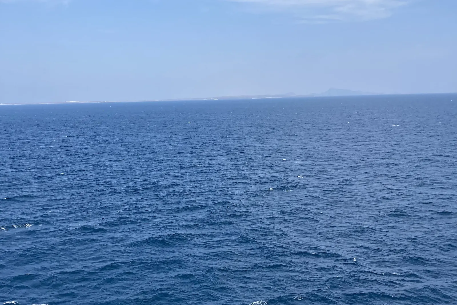 The Bab el-Mandeb strait seen from mid-channel, with Yemen in the distance