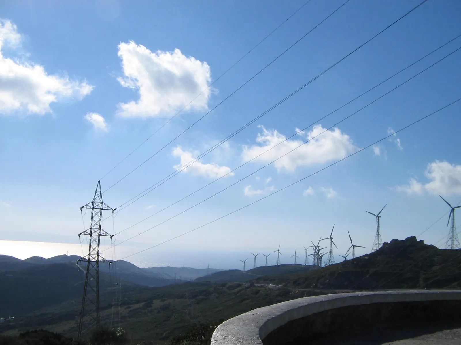 A power line and wind turbines in Andalusia, Spain