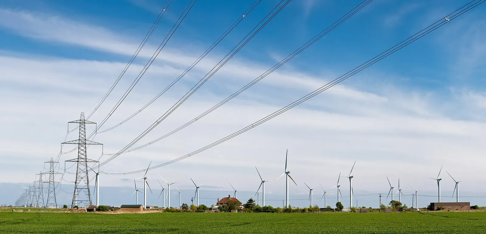 A wind farm and power lines near Rye, East Sussex, England